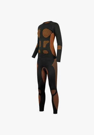 Black and orange athletic long-sleeve top and leggings featuring patterned panels, textured accents, and ergonomic seams for fit and flexibility.