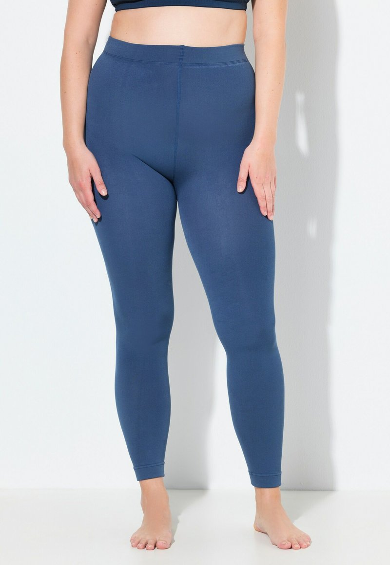 Dunkelblaues Leggings mit glatter Textur, hohem Taillendesign und schmalem Bein. Keine sichtbaren Nähte oder Muster. Die Füße sind barfuß.