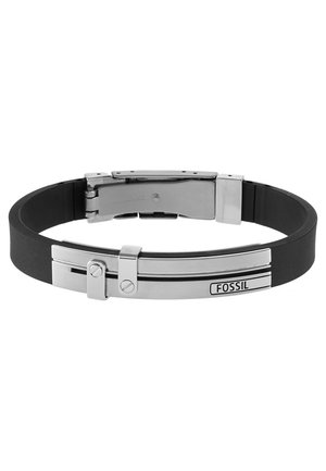 Schwarzes Silikonarmband mit silbernem Metallverschluss und dekorativer Platte mit eingraviertem Fossil Markennamen.