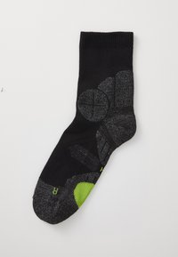Zwarte sok met een gestructureerd donkergrijs patroon en groene accenten. Inclusief verstevigde hiel- en teengebieden voor duurzaamheid.