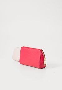 Two rectangular zippered leather pouches, one bright red in front and one beige behind, on a white background.