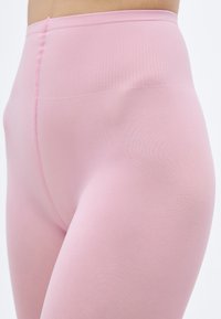 Κολάν με ψηλή μέση, εφαρμοστό σε απαλό ροζ χρώμα, κατασκευασμένο από ελαστικό ύφασμα με απαλή υφή και ριμπ ζώνη μέσης.