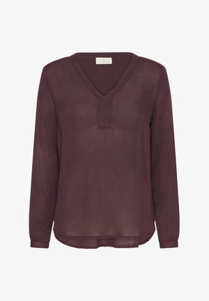 Blouse violette à manches longues avec un décolleté en V et un petit détail de patte, présentant un tissu lisse et texturé et un ourlet arrondi.