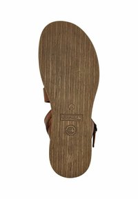 Hnědá podrážka sandálů s texturovaným, pruhovaným vzorem. Obsahuje logo "Toms" a razítko velikosti 37 blízko paty. Plochý tvar a odolný materiál.