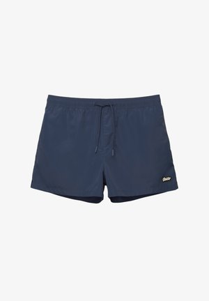 Sötétkék fürdőnadrág könnyű anyagból, rugalmas derékkal és húzózsinórral, az oldalon egy kicsi logóval.