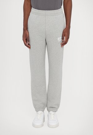 Gray sweatpants made of soft fabric, featuring an elastic waistband and cuffed ankles. A small white logo is visible on the left thigh.