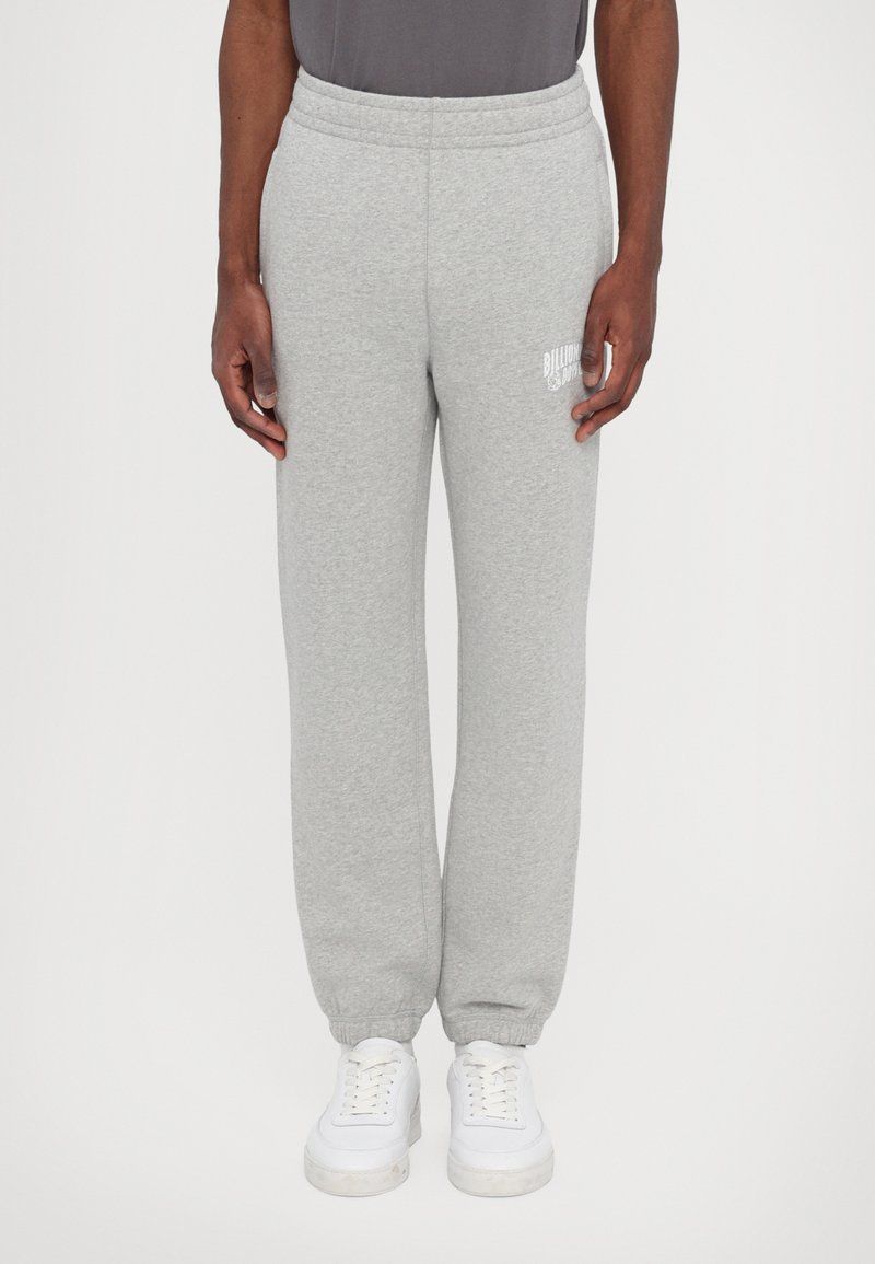 Gray sweatpants made of soft fabric, featuring an elastic waistband and cuffed ankles. A small white logo is visible on the left thigh.