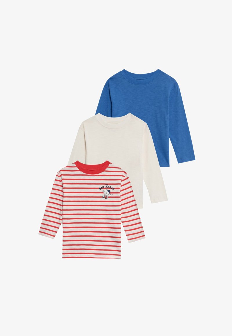 Drie longsleeve shirts: één blauwe, één crèmekleurige en één witte met rode strepen, met een cartoonfiguur en de tekst "BIG APPLE" op de voorkant.