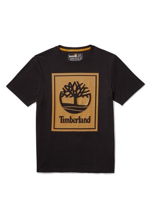T-shirt noir à manches courtes avec un grand carré beige présentant un arbre stylisé et le mot « Timberland » centré sur le devant.