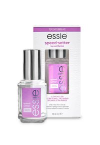 Bouteille en verre transparent avec un capuchon en métal argenté, contenant un vernis à ongles transparent. La boîte violette présente le nom du produit et des instructions de séchage.