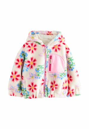 Veste en polaire avec un motif floral en rouge, rose et bleu sur un fond crème. Caractéristiques d'une poche zippée rose et d'une capuche. Texture douce.