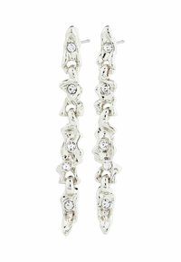 Pendientes en tono plateado con un diseño entrelazado, que presentan piedras preciosas transparentes incrustadas. Acabado suave, forma alargada y textura pulida.