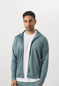 Under Armour RIVAL KNIT - Tracksuit - jasper blue/serpentine