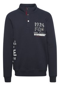 Sweatshirt bleu marine avec col montant, patte de boutonnage à trois boutons et graphiques sur le devant. Tissu texturé avec ourlet et poignets côtelés.