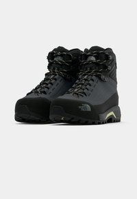 Juodi žygio batai su tekstūruotu viršumi, sustiprintu nosimi ir tvirtu protektoriumi. Turi tvirtas raištelius ir prekės ženklo akcentus, užtikrinančius atramą.