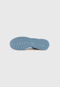 Blue rubber sneaker sole with patterned tread and logo detail. Features a rounded toe and smooth texture. Flat design for traction.