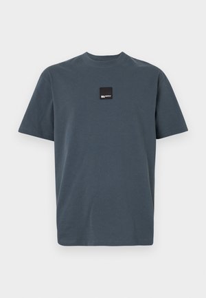 Dark grey, short-sleeve t-shirt made of cotton with a crew neck. Features a small black square label on the chest. Soft texture.
