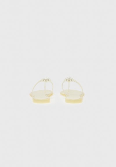 Yellow, translucent sandals with flat soles, open toe design, and a minimalistic strap with a circular accent on the upper part.