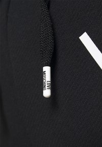 Black fabric with a textured finish, featuring a white drawstring with a branding tag that reads "LOVE MOSCHINO" in black text.