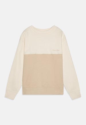 Bluza z okrągłym dekoltem i długimi rękawami, w kolorach cream i beige w stylu color-block, z subtelnym logo Calvin Klein na piersi.