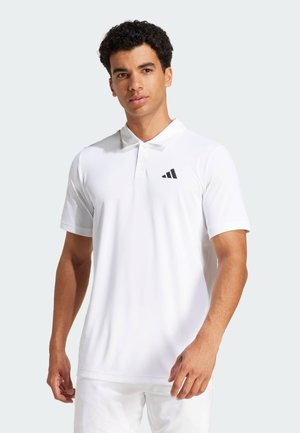 Balta polo marškinėliai pagaminti iš poliesterio, su juodu Adidas logotipu ant kairės krūtinės. Trumpomis rankovėmis ir klasikiniu apykaklės dizainu.