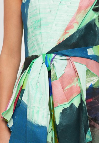 Colorful dress with a mix of green, pink, and blue patterns. Features a tied waist, pleating, and a flowing, textured fabric.