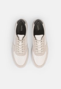 Weiße Leder- und Wildledersneaker mit runder Spitze, perforiertem Obermaterial und flachen Schnürsenkeln. Schwarze Innenverkleidung und Logo auf der Innensohle. Gummiaußensohle.