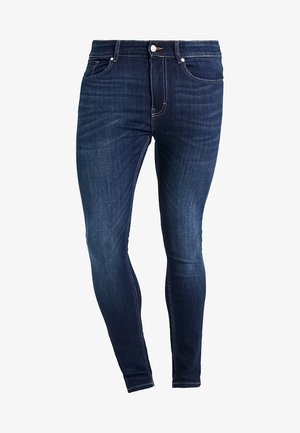 Dark blue denim jeans with a slim-fit design, five-pocket style, and contrast stitching details. Material appears smooth with slight texture.