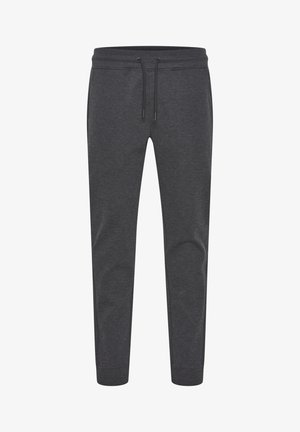 Donkergrijze joggers van een zachte, rekbare stof. Voorzien van een elastische tailleband met een trekkoord en taps toelopende benen met geribbelde boorden.