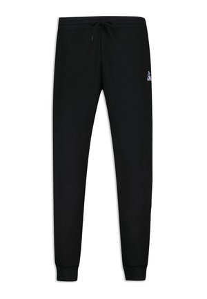 Pantalones de chándal negros hechos de una tela suave, con una cinturilla elástica y un cordón, puños en los tobillos y un pequeño logo como acento.