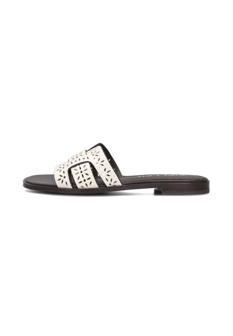Slide sandal with a cream upper featuring cut-out floral patterns, and a dark brown flat sole. Simple, open-toe design for easy wear.