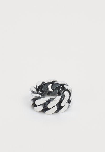 Metalring med sammenflettede kjedeledd i en blanding av polert og matte sølvfinish, noe som gir et teksturert og dristig design.
