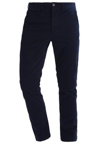 Mörkblå chinos i bomull med slim-fit-design, framfickor och knappstängning med dragkedja.