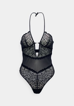 Bodysuit de lingerie preta com decote profundo, tecido de malha transparente, padrões de renda geométricos e acabamentos em pico. Alças ajustáveis.