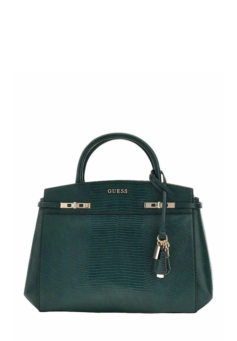 Sac à main vert texturé avec accessoires dorés, doubles poignées et un charme décoratif. Présente un design structuré et une fermeture zippée.