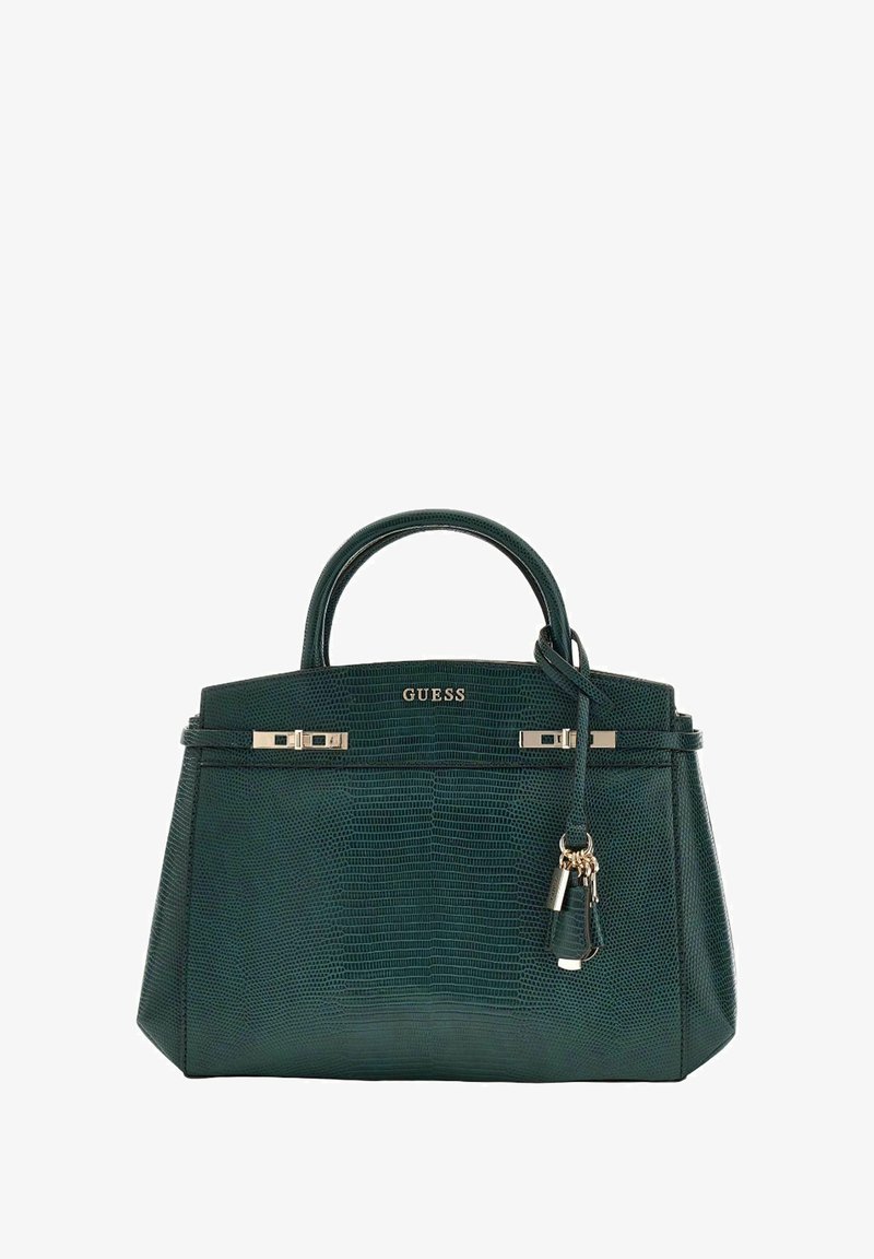 Sac à main vert texturé avec accessoires dorés, doubles poignées et un charme décoratif. Présente un design structuré et une fermeture zippée.