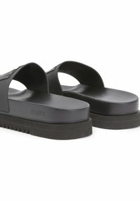 Black slide sandals with two wide straps, made of glossy material, featuring a textured sole and a slight platform for added height.
