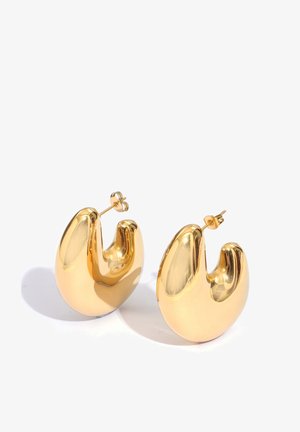 Pair of shiny gold hoop earrings with a thick, curved design and post backings on a white background.