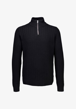 Musta neule, jossa on korkeakauluksinen malli ja puolivetoketju. Teksturoitu pystynolkkakuvio. Pitkät hihat, resorireunukset ja -helma. Valmistettu lämpimästä neulomateriaalista.