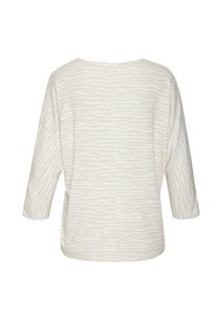 Light beige top with a zebra stripe pattern, featuring three-quarter sleeves and a wide neckline, made from soft fabric.