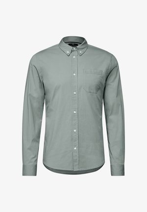 Lange mouw knopsluiting shirt van lichtgroene katoen. Beschikt over een kraag, een borstzak en een subtiele textuur met een ronde zoom.