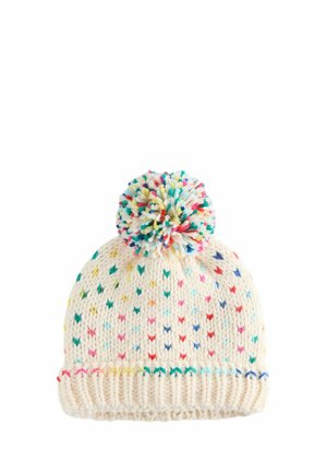 White knitted beanie with a colorful pom-pom on top. Features a pattern of small, multicolored V-shaped stitches and a ribbed brim.
