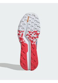 Shoe sole with a white base, red accents, and textured grip pattern. Features prominent triangular treads for enhanced traction and durability.
