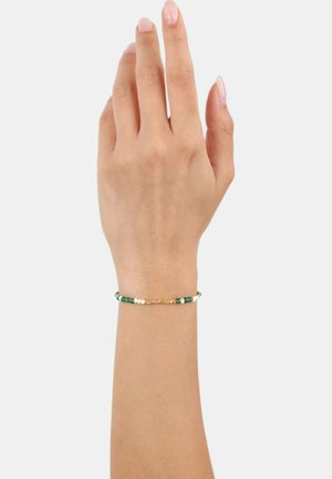 Bracciale di perline verde e bianco con dettagli dorati, caratterizzato da piccole perline rotonde di diverse dimensioni e un design delicato.