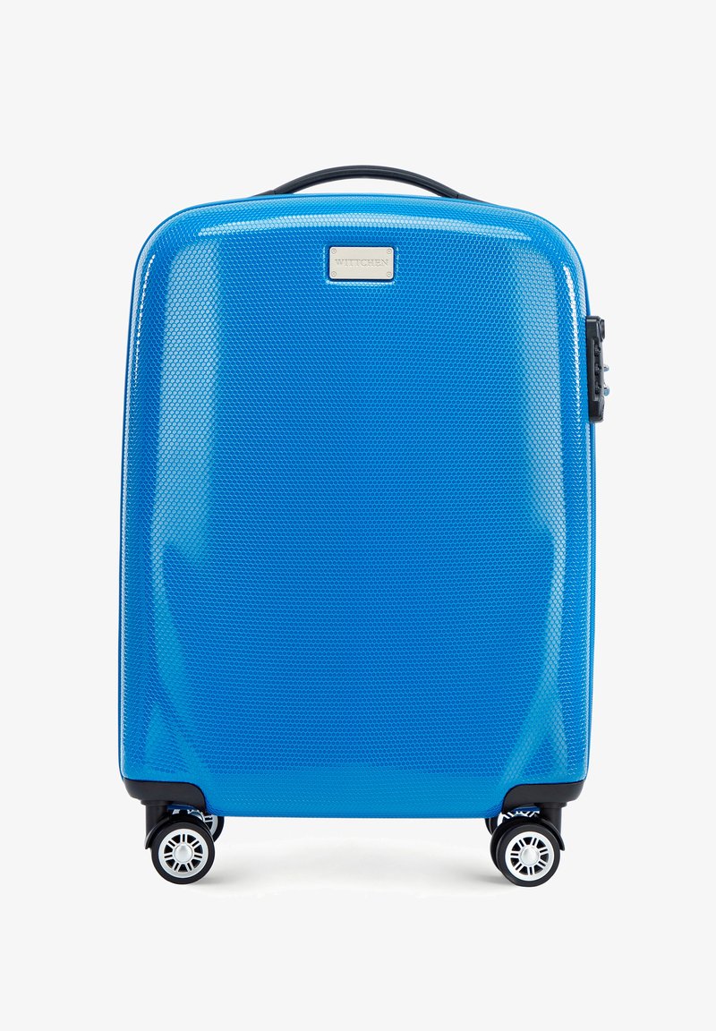 Valise rigide de couleur bleu vif avec un motif en nid d'abeille texturé. Equipée de quatre roulettes noires, d'une poignée supérieure et d'un cadenas à combinaison.