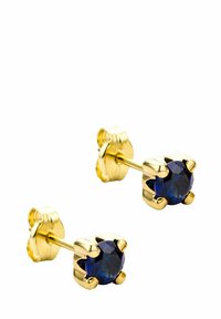 Pendientes de oro en forma de tuerca con piedras preciosas azules redondas, montadas en un diseño de garra. Superficie lisa con acabado pulido, que resalta el profundo color de las piedras.