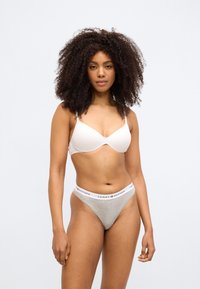 Világos rózsaszín melltartó sima anyagból, állítható pántokkal, szürke tanga, fehér derékpánttal, rajta piros logófelirat.