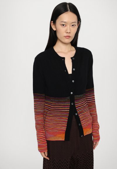 Black cardigan with multicolored horizontal stripes in red, orange, and yellow. Features a round neckline and front button closure.