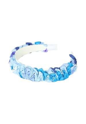 Bandeau en tissu bleu et violet avec un design de volants froncés, présentant une surface intérieure lisse et une finition brillante.
