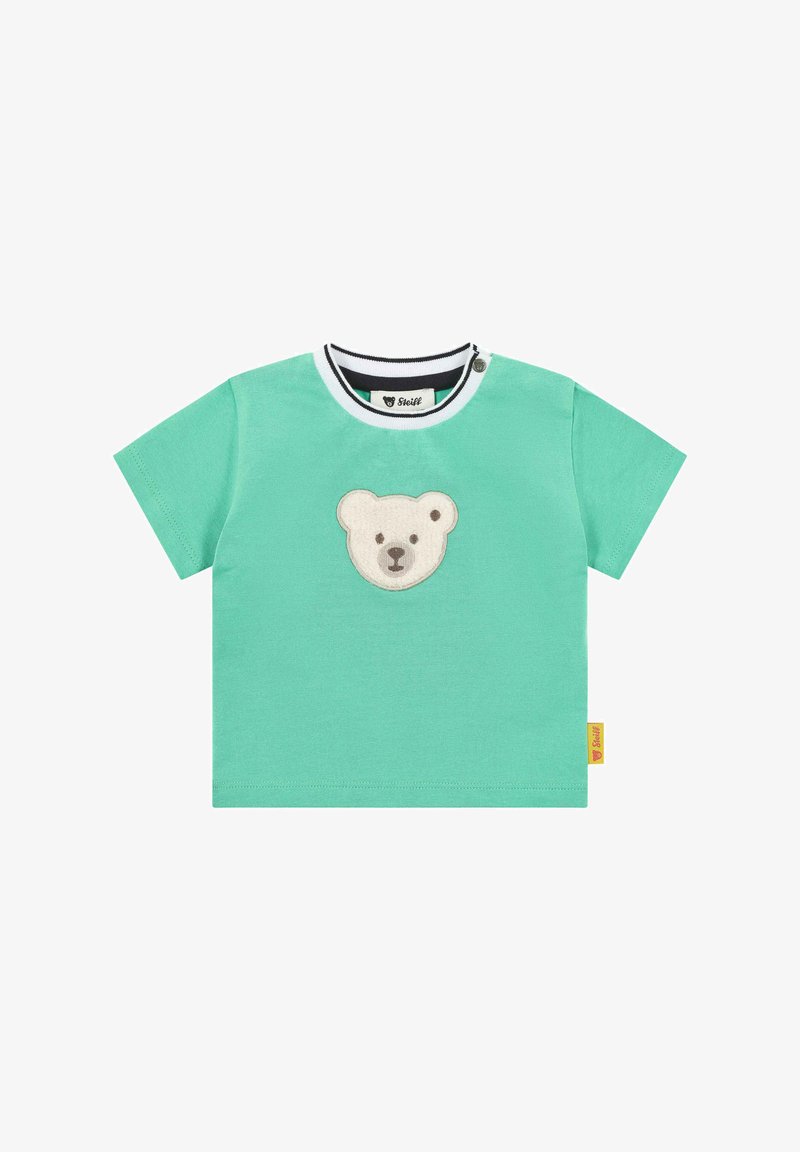 Tyrkysové tričko s krátkým rukávem vyrobené z bavlny, s aplikací medvědí tváře na přední straně a černo-bílým pruhovaným límečkem. Štítek na boku.